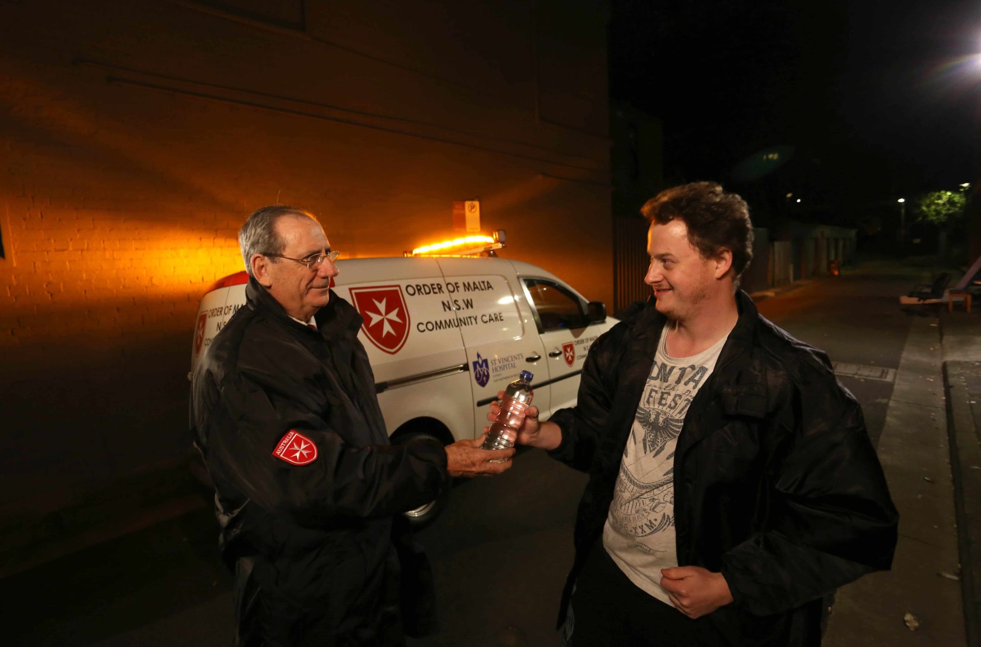 David Hall of the Order of Malta, pictured here distributing Coats for the Homeless, is now turning his sights on sun protection for the homeless this summer.