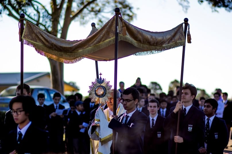 Surrounded by students including canopy bearers, Wollemi College assistant chaplain Fr Max Polak carries the Blessed Sacrament in a monstrance during the school’s procession commemorating the Feast of Corpus Christi, which was held on 9 June. 