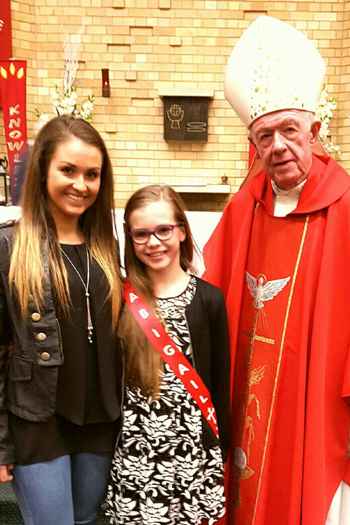 Bishop Terry Brady, auxiliary bishop of Sydney, with a confirmation candidate and her sponsor at St John Bosco parish, Engadine, on 14 August.