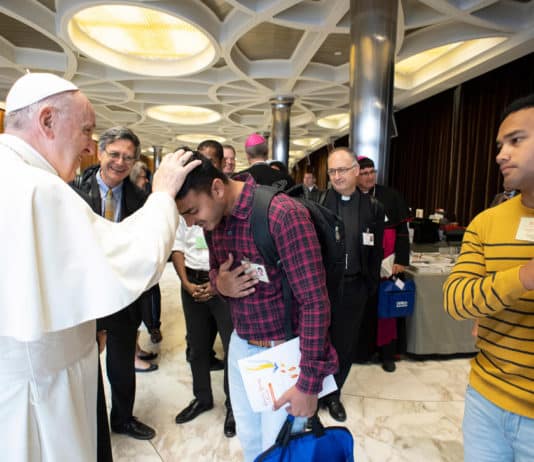 Pope Francis blesses young man at Youth Synod