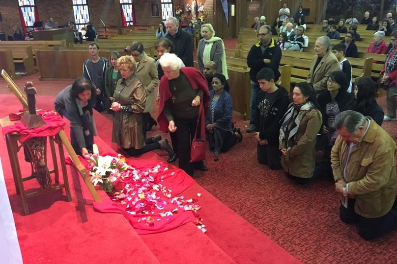 Touched by mercy: participants come forward to place prayer intentions, pray and venerate relics of St Mary MacKillop and St Teresa of Calcutta at St Michael’s church in Baulkham Hills parish last weekend. 
