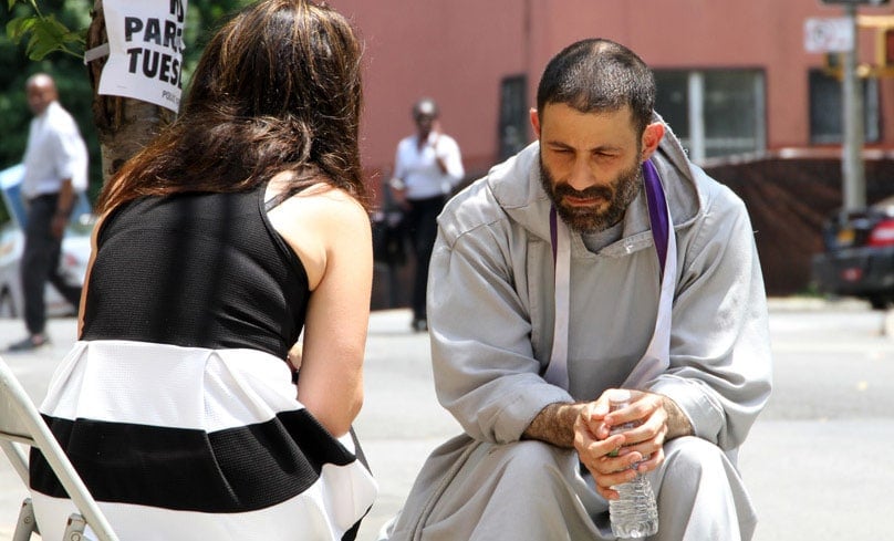 A Franciscan priest hears confessions outdoors at a gathering in New York. Photo: CNS, Gregary Shemitz