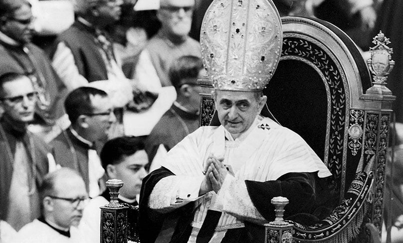 Pope Paul VI makes his way past bishops during a session of the Second Vatican Council in 1964. Photo: CNS file photo