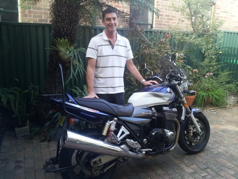 Patrick Mara and the Suzuki he will ride to Darwin. 