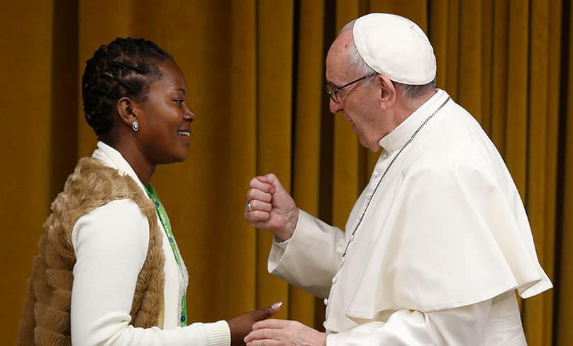 Pope Francis greets Tendai Karombo from Zimbabwe during a pre-synod gathering of youth delegates. Photo: CNS photo/Paul Haring
