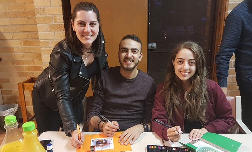St Felix youth members Tracey, Anthony and Jacinta Eltarraf work on their Christmas Cards for the children of Mozambique. Photo: Mathew De Sousa