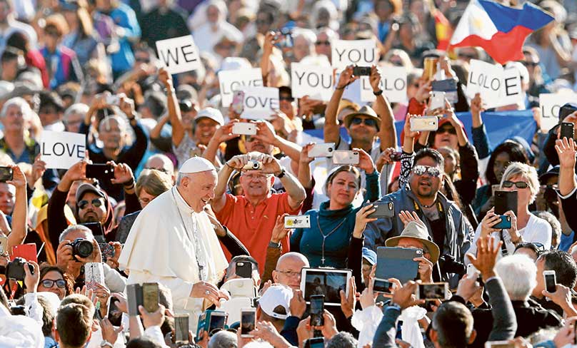 Signs expressing love for Pope Francis are seen as he greets the crowd during his general audience on 10  October in St. Peter's Square at the Vatican. Photo: CNS photo/Paul Haring