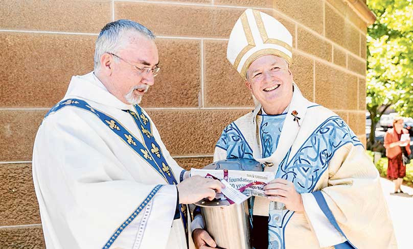 Cathedral Dean Fr Don Richardson, above, assists Archbishop Anthony Fisher OP with the 2018 time capsule at the sesquicentenary celebration of the blessing of the foundation stone of St Mary’s Cathedral in 1868. Photo: Alphonsus Fok