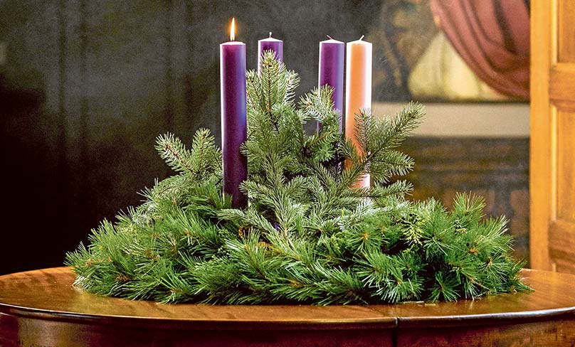 A lit candle is seen on an Advent wreath. Photo: CNS/Lisa Johnston, St Louis Review