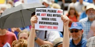 A woman holds up a sign during a rally against assisted suicide in Ottawa, Ontario. Photo: CNS