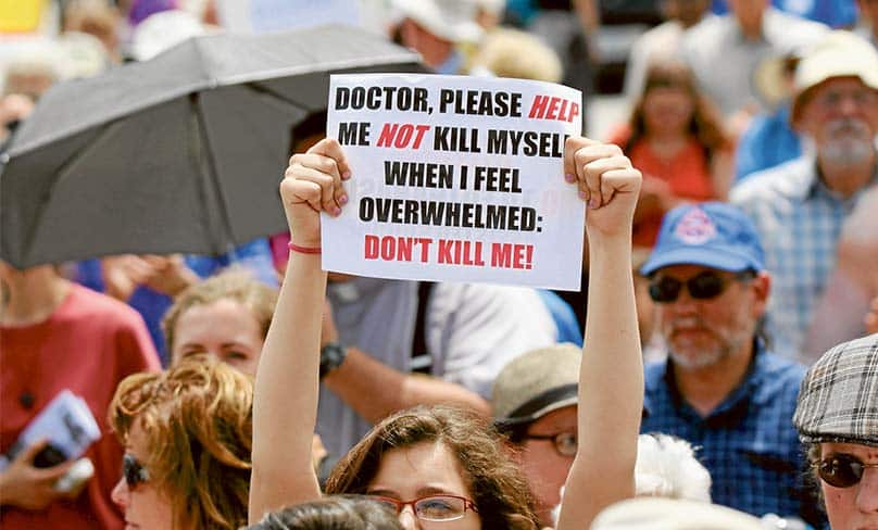 A woman holds up a sign during a rally against assisted suicide in Ottawa, Ontario. Photo: CNS