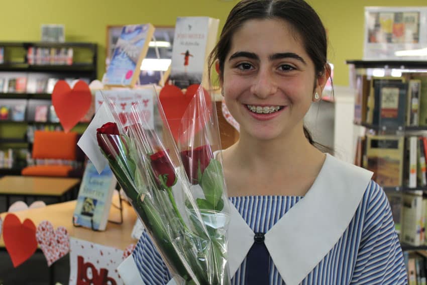 Student Bianca Rice enjoys distributing the roses.