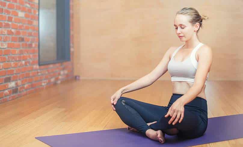 Woman excising with yoga.