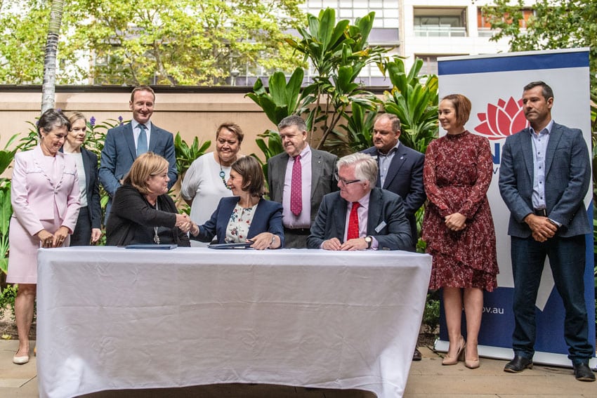 NSW Premier Gladys Berejiklian and Chair of the Institute of Global Homelessness, Dame Louise Casey shake hands after signing the agreement to halve rough sleeping in NSW by 2025. Photo: Giovanni Portelli
