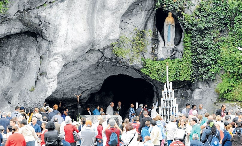 Pilgrims visit the grotto where Mary appeared in Lourdes, France.Main Photo: CNS/Jose Navarro, EPA