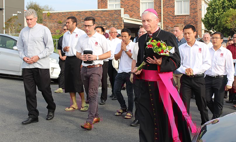 Bishop Patrick Dunn of Auckland carries flowers to place at Al-Jamie Mosque to memorialise victims of the March 15 mosque attacks in Christchurch. Photo: CNS photo/Michael Otto, NZ Catholic