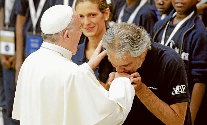 Italian tenor Andrea Bocelli kisses Pope Francis’ hand on 2 August 2017 after performing during the pontiff’s weekly audience. Photo: CNS/Max Rossi, Reuters