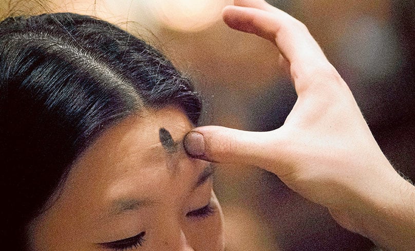 A cross is marked on the forehead of a woman during Ash Wednesday Mass at St. Patrick's Cathedral in New York City. Photo: CNS photo/Adrees Latif, Reuters
