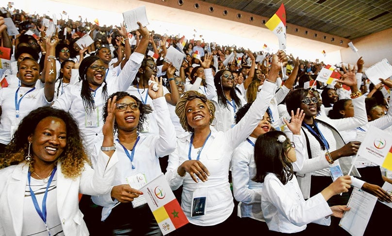 Choir members sing and wave flags as Pope Francis arrives to celebrate Mass at Prince Moulay Abdellah Stadium in Rabat, Morocco, 31 March. Photo: CNS photo/Paul Haring