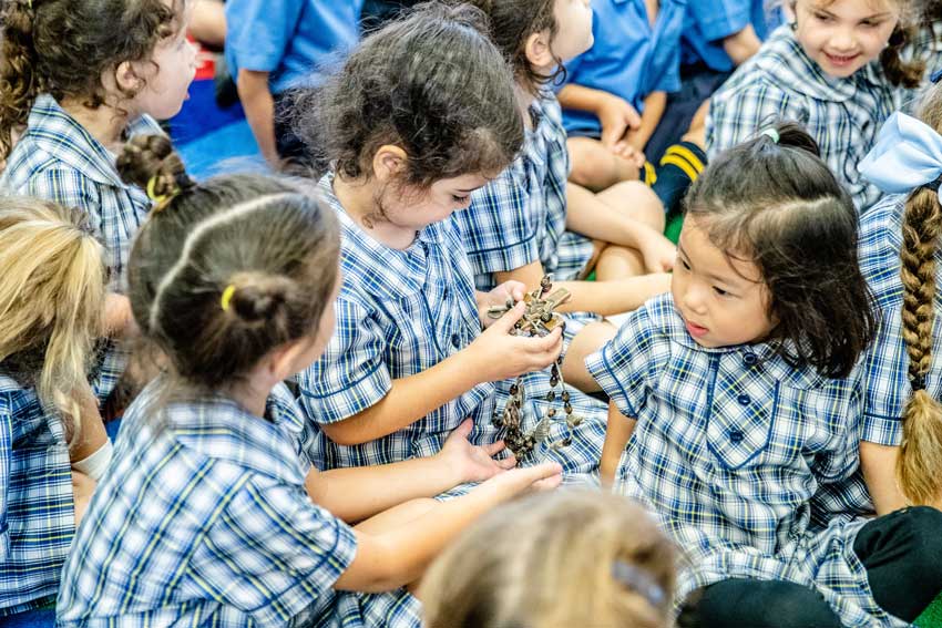 Primary students discuss the rosary prayer