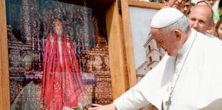 Pope Francis touches an image of the Infant of Prague. Photo: Vatican Media