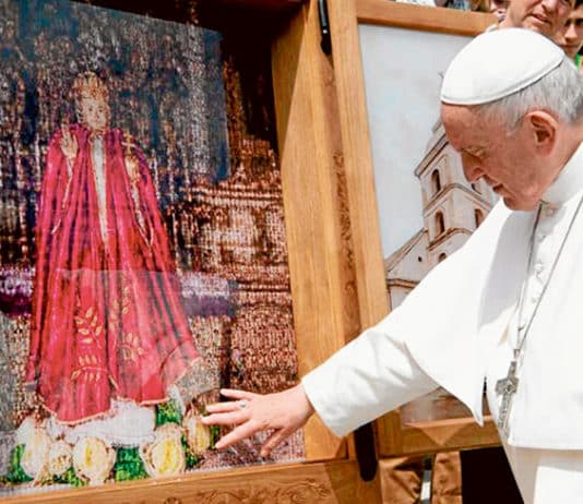Pope Francis touches an image of the Infant of Prague. Photo: Vatican Media