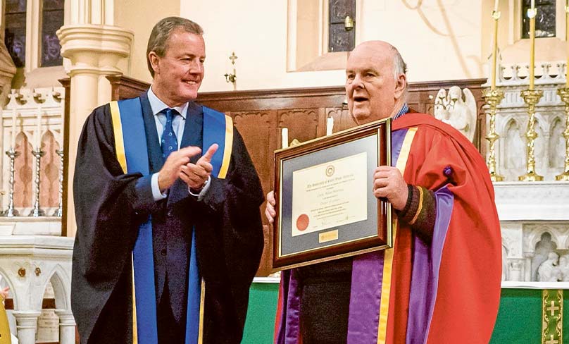 Australia’s unofficial poet laureate, pictured with then-Deputy Chancellor Peter Prendiville, receives an honorary doctorate at Notre Dame in 2015.