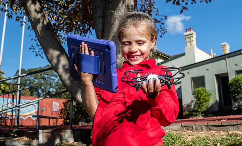 A year one student preparing to launch a drone at Our Lady of Mount Carmel. Photo: Alphonsus Fok