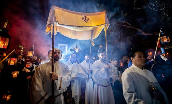 Flanked by incense-bearers and lanterns held high and followed by a long line of candle-bearing faithful, the Blessed Sacrament was processed from St Jerome's, Punchbowl, to St Charbel’s where there was Benediction and a Maronite Mass in English. Photo: Giovanni Portelli