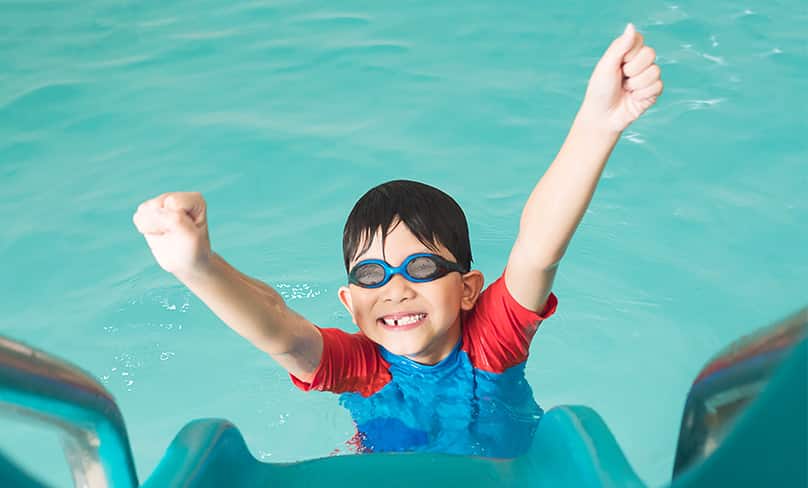 Child happy in swimming pool.