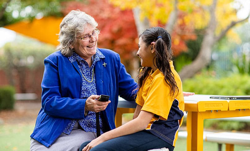 Sr Patricia Bailey OAM with hearing impaired student Grace Kambour. Photo: Alphonsus Fok