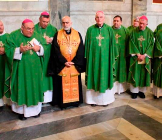 Bishop Christopher A. Saunders of Broome, Australia, left, gestures as he prays with other Australian bishops at the tomb of Francis Xavier Conaci at the Basilica of St. Paul Outside the Walls in Rome. Photo: CNS photo/courtesy Gavin Abraham, Australian Catholic Bishops Conference