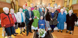 Bishop Terry Brady, Parish Priest Fr Salas Muttathukattil MSFS, parishioners and sisters including Sr Mary Constable, centre, gather for the farewell. Photo: Patrick Lee