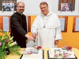 Fr Smithers and Archbishop Fisher cut the cake. Photo:: Alphonsus Fok