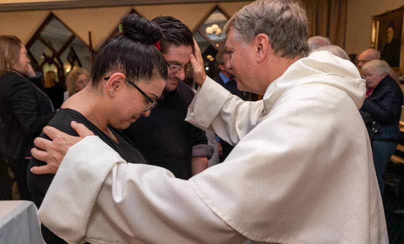 Archbishop Anthony Fisher OP blesses a couple after Mass marking the 40th anniversary of the Ephpheta Centre. Photo: Patrick J Lee