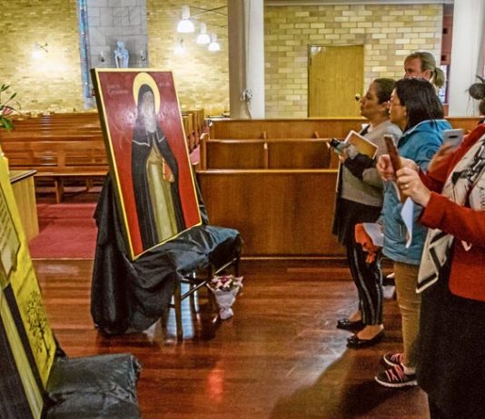 Staff and students view the new icons for Santa Sabina College in Strathfield. Photo: Brian Walker
