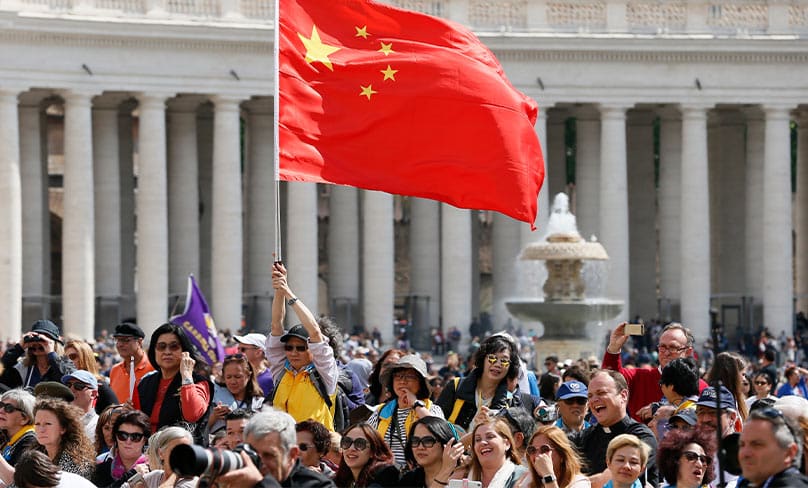 A man waves China’s flag as Pope Francis leads his general audience in May.Photo: CNS/Paul Haring