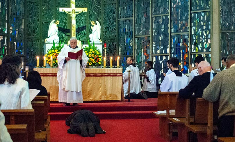 Conventual Franciscan Brother Bernard Mary Fonkalsrud OFM Conv prostrates himself before the altar as the Litany of Saints is sung. Photo: Mathew De Sousa 