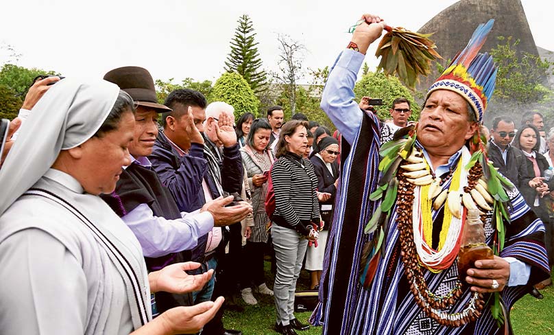 Isidoro Jajoy, a shaman from Colombia’s Inga tribe, blesses people in Bogota during a preparatory meeting for the October Synod of Bishops for the Amazon. Photo: CNS photo/Manuel Rueda 