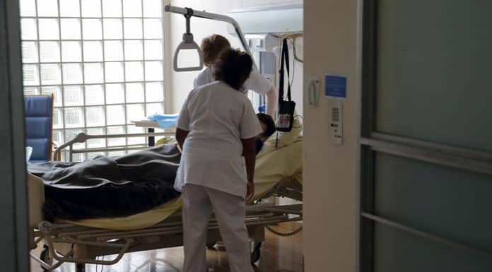 Nurses provide care to a patient in the palliative care unit of a hospital near Paris. Photo: CNS photo/Philippe Wojazer, Reuters