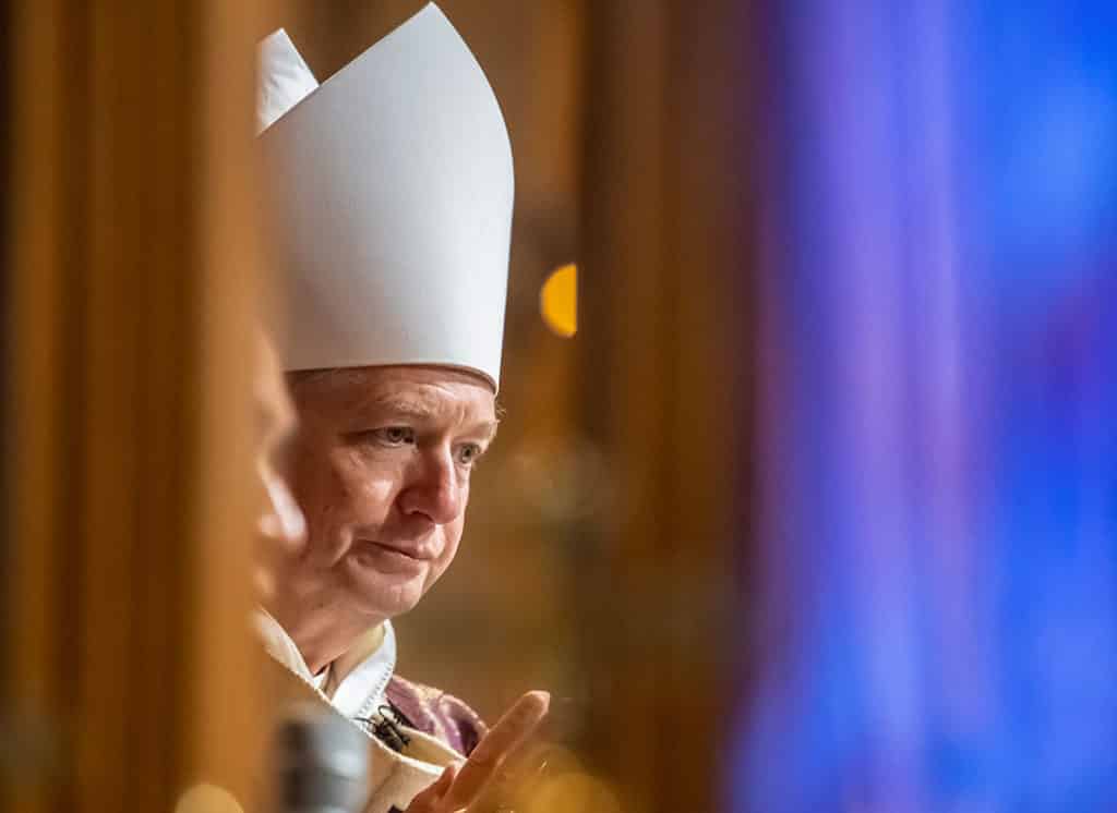 Archbishop Anthony Fisher OP reflects during Mass in St Mary's Cathedral. Archbishop Fisher has "with a heavy heart" ordered the closure of all churches in the Archdiocese of Sydney.