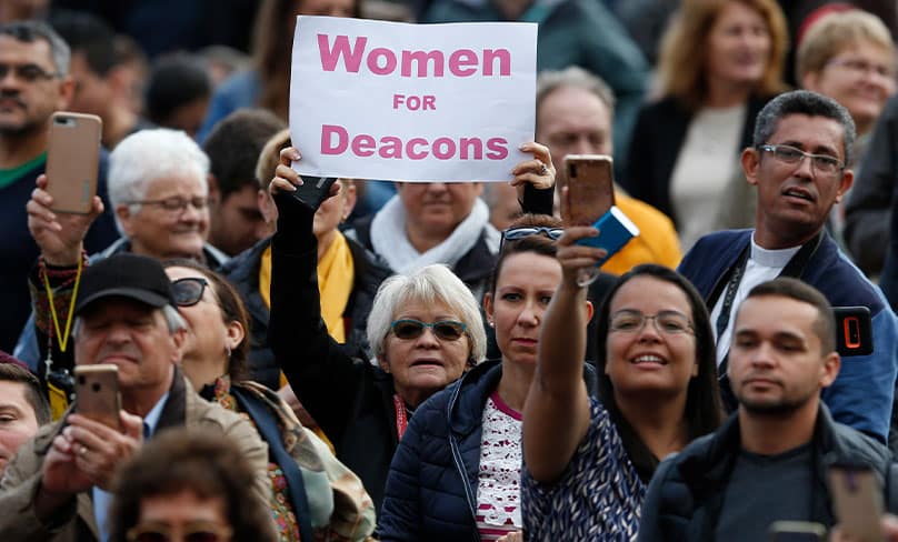 A woman holds a sign in support of women deacons as Pope Francis leads his general audience in St Peter’s Square at the Vatican in November 2019. Photo: CNS photo/Paul Haring