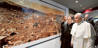 Pope Francis walks by a photo showing the destruction created by an atomic bomb during his visit to the Jesuit-run Sophia University in Tokyo. Photo: CNS/Vatican Media via Reuters