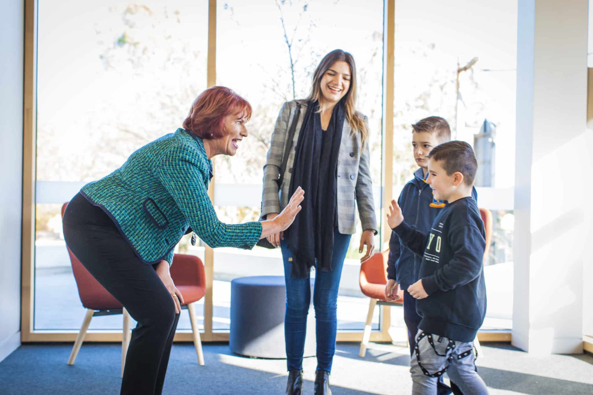 Five Dock’s All Hallows Catholic Primary School Principal Helen Elliott welcomes a family in to school PHOTO: Giovanni Portelli