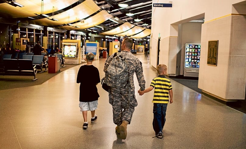 Father Soldier Son: Isaac, left, and Joey Eisch with their father, Sergeant First Class Brian Eisch, on his return from Afghanistan from leave. Photo: Cr. Marcus Yam, New York Times, Netflix 2020