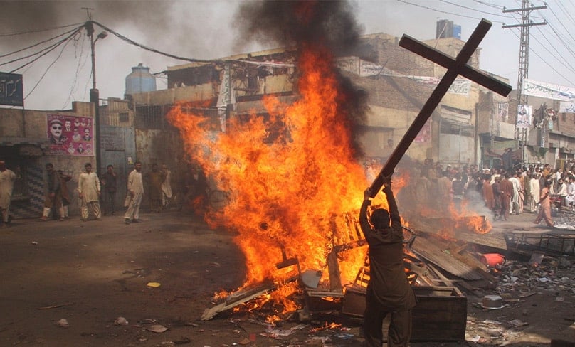 A demonstrator burns a cross during a protest in the Badami Bagh area of Lahore, Pakistan, in 2013. Photo: CNS, Adrees Hassain, Reuters