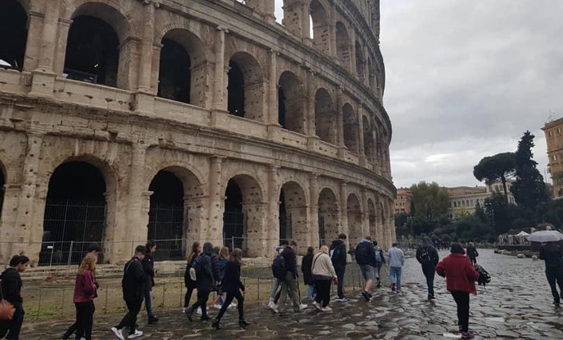 Students participating in the ACU School Leavers Program walk alongside the infamous Colosseum in Rome, Italy. Photo: courtesy ethan westwood