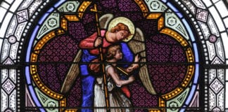 A guardian angel is depicted i stained glass window in St Joseph's church in Greenwich Village, NYC. Photo: Lawrence OP/Flickr, CC BY-NC-ND 2.0
