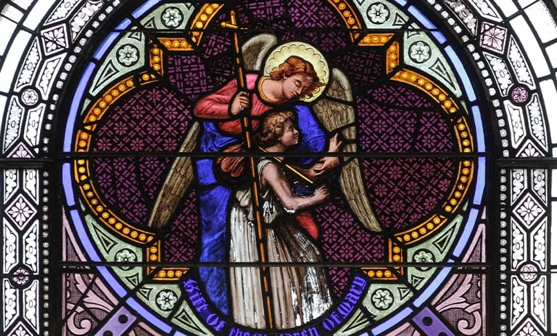 A guardian angel is depicted i stained glass window in St Joseph's church in Greenwich Village, NYC. Photo: Lawrence OP/Flickr, CC BY-NC-ND 2.0