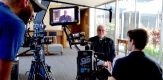 Jonathan Cipiti interviews Holy Cross Father David Guffey at the Family Theater Productions offices in Los Angeles in 2018 during the making of the 2020 documentary "Pray: The Story of Patrick Peyton." Photo: CNS photo/Family Theater Productions